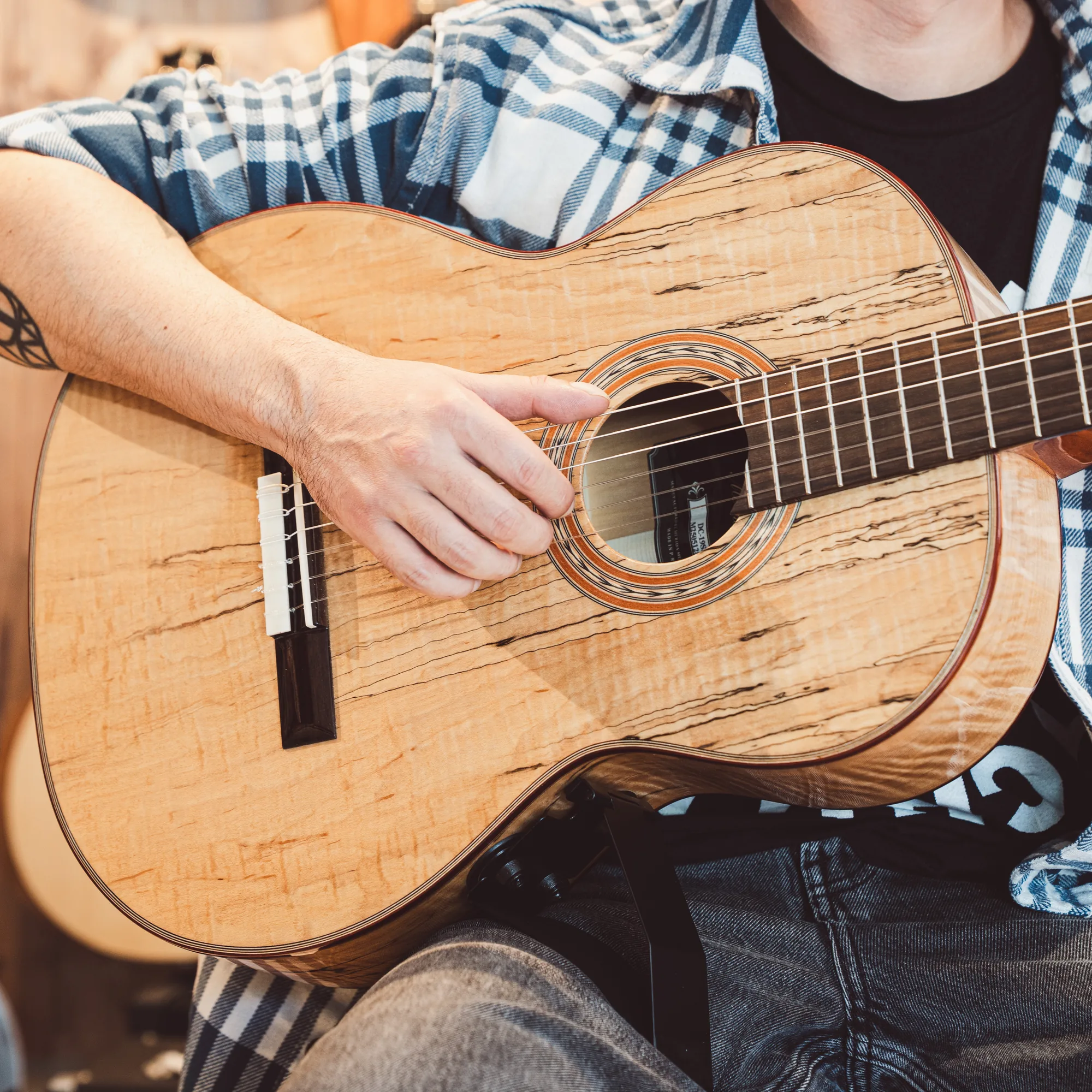 Child playing guitar with Gitano support